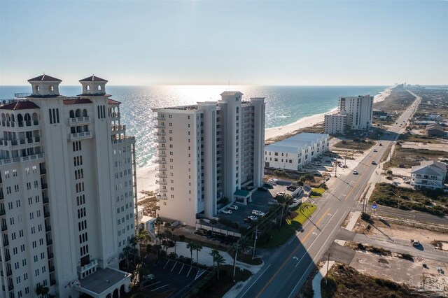 bird's eye view with a water view and a beach view