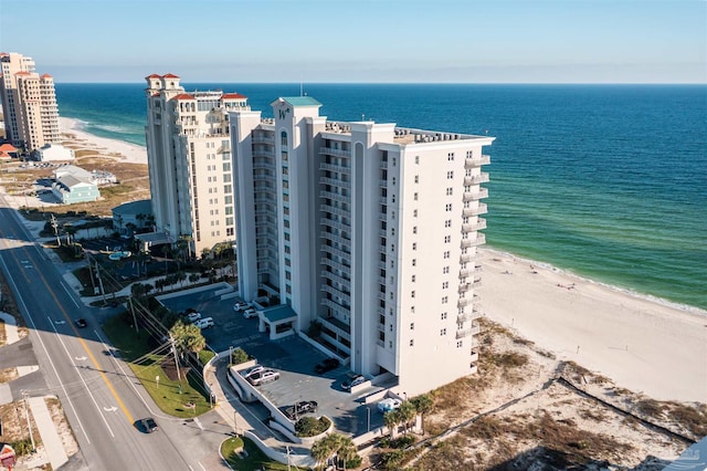 drone / aerial view featuring a water view and a beach view