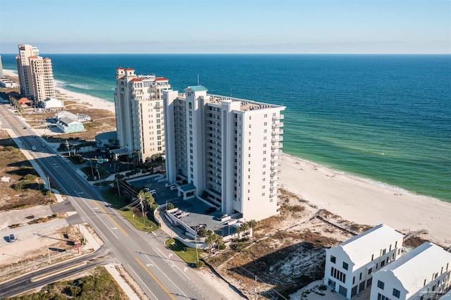 aerial view with a water view and a beach view