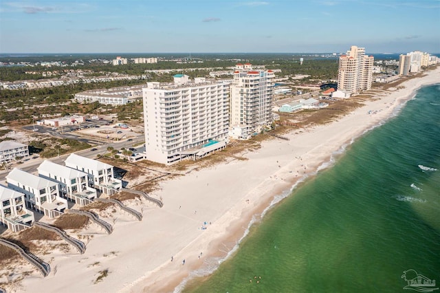 birds eye view of property featuring a water view and a beach view