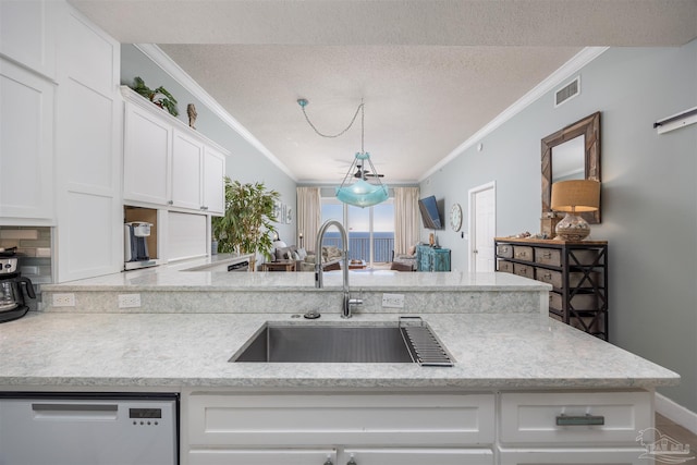 kitchen featuring white dishwasher, crown molding, white cabinetry, and sink