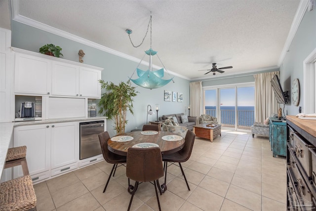 dining space featuring a textured ceiling, ceiling fan, ornamental molding, and light tile patterned flooring