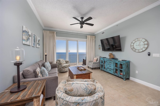 living room featuring light tile patterned floors, a textured ceiling, ceiling fan, and crown molding