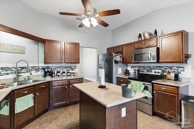 kitchen with sink, decorative backsplash, stainless steel appliances, and a center island