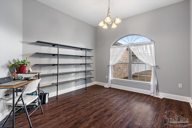 unfurnished office featuring dark wood-type flooring and an inviting chandelier