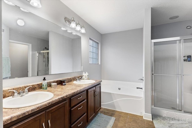 bathroom with vanity, tile patterned floors, shower with separate bathtub, and a textured ceiling