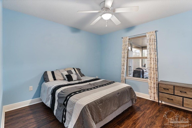 bedroom with dark wood-type flooring and ceiling fan