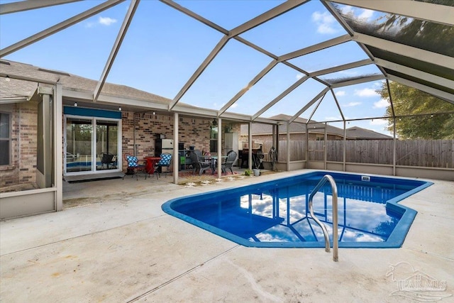 view of swimming pool with a patio and glass enclosure