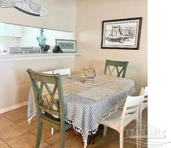 dining room with light tile patterned flooring