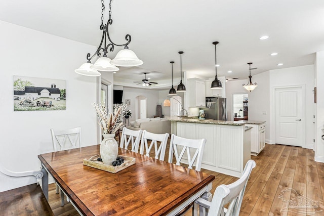 dining space with recessed lighting, a ceiling fan, and light wood-type flooring