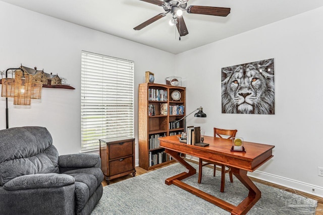 office space with wood finished floors, baseboards, and ceiling fan