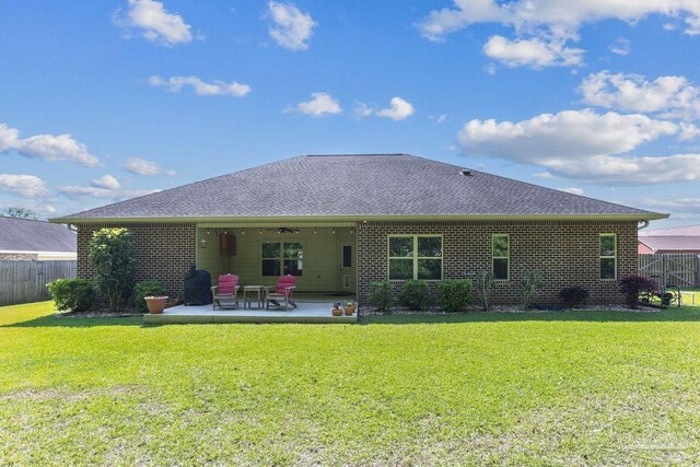 back of property featuring fence, ceiling fan, and brick siding