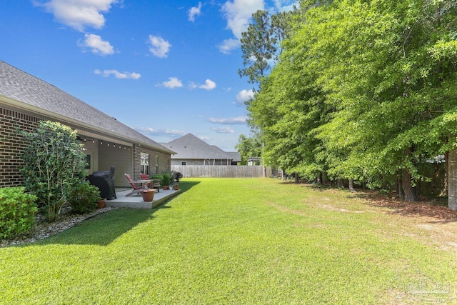 view of yard featuring fence and a patio