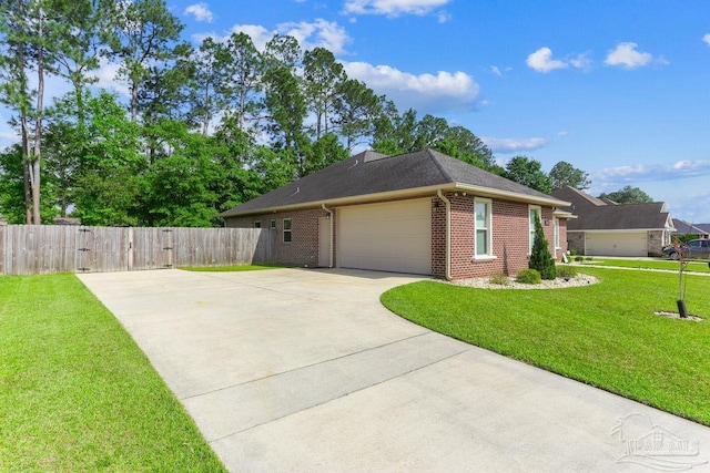view of home's exterior featuring concrete driveway, fence, brick siding, an attached garage, and a yard