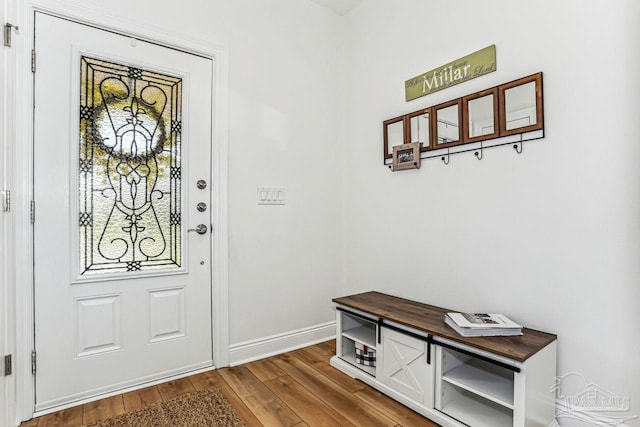interior space featuring baseboards and wood finished floors