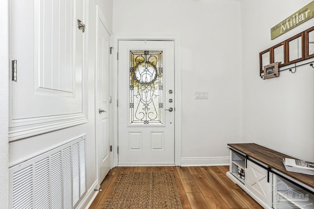 entryway with baseboards, wood finished floors, and visible vents