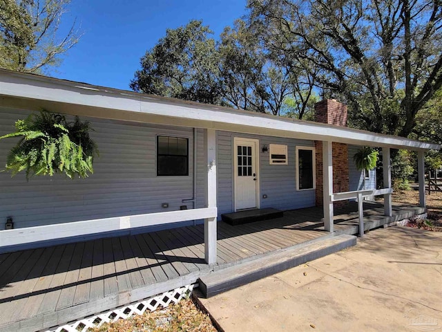 5927 Mitchell Ln, Pensacola, FL 32526 - doorway to property featuring covered porch and a chimney