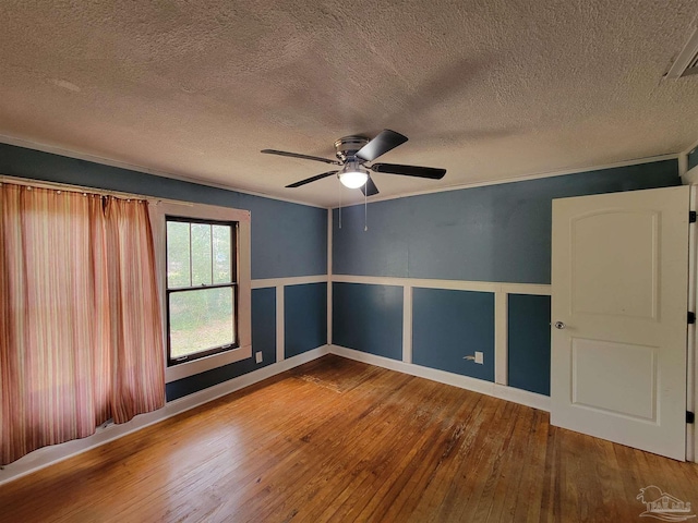 5927 Mitchell Ln, Pensacola, FL 32526 - empty room with ornamental molding, a textured ceiling, ceiling fan, and hardwood / wood-style floors