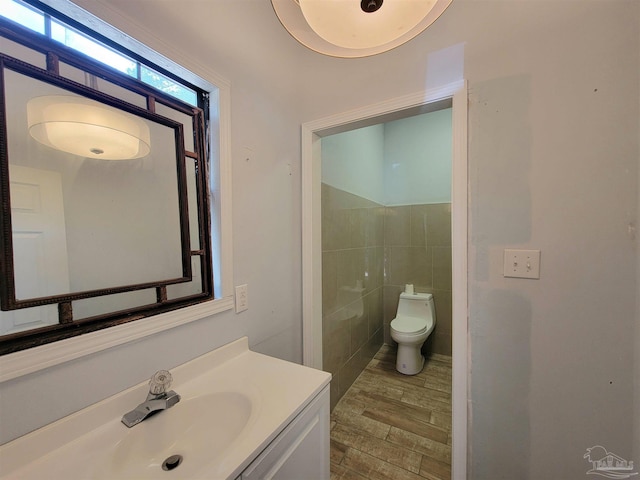 5927 Mitchell Ln, Pensacola, FL 32526 - bathroom with toilet, vanity, tile walls, and wood finished floors
