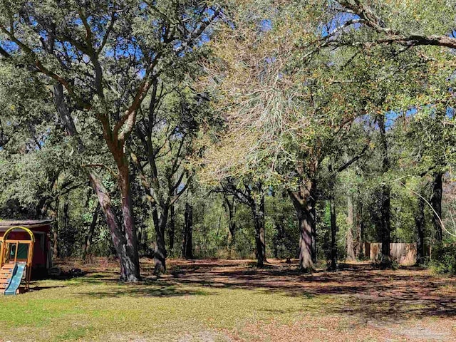 5927 Mitchell Ln, Pensacola, FL 32526 - view of yard with a forest view and a playground