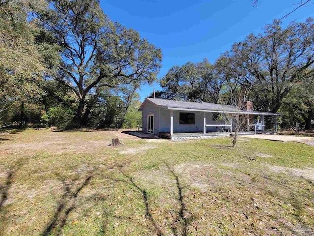 5927 Mitchell Ln, Pensacola, FL 32526 - view of front of property featuring a front lawn, a carport, driveway, and a chimney