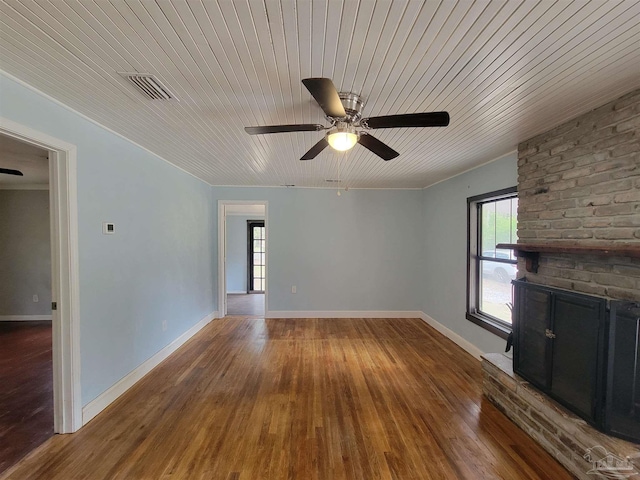 5927 Mitchell Ln, Pensacola, FL 32526 - unfurnished living room featuring visible vents, baseboards, a fireplace, wood finished floors, and a ceiling fan