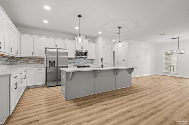 1192 Adrian Way, Milton, FL 32583 - kitchen with appliances with stainless steel finishes, tasteful backsplash, light countertops, light wood-style flooring, and recessed lighting