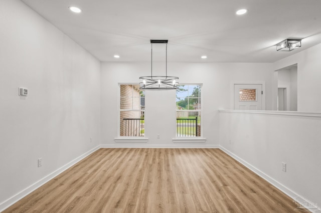 1192 Adrian Way, Milton, FL 32583 - unfurnished dining area with wood finished floors, recessed lighting, a chandelier, and baseboards