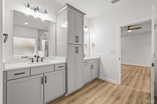 1192 Adrian Way, Milton, FL 32583 - full bathroom with two vanities, wood finished floors, ceiling fan, and baseboards