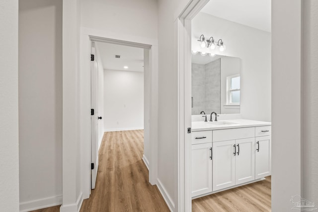 1192 Adrian Way, Milton, FL 32583 - bathroom featuring wood finished floors, vanity, and baseboards