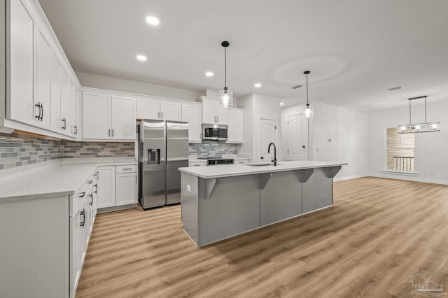 1192 Adrian Way, Milton, FL 32583 - kitchen featuring appliances with stainless steel finishes, a sink, backsplash, white cabinets, and recessed lighting