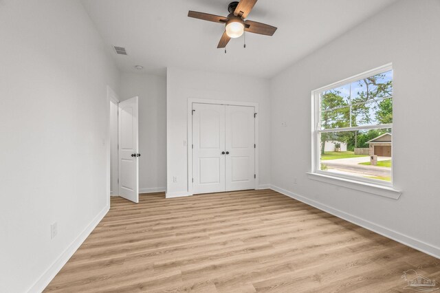 1192 Adrian Way, Milton, FL 32583 - unfurnished bedroom featuring baseboards, light wood-style flooring, a closet, and a ceiling fan