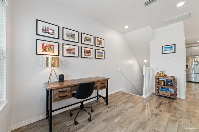 office with light wood-type flooring