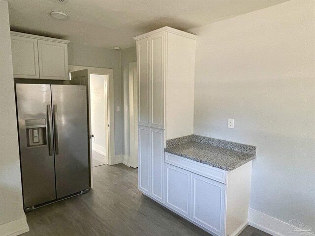 kitchen featuring stone counters, white cabinetry, stainless steel refrigerator with ice dispenser, and hardwood / wood-style floors