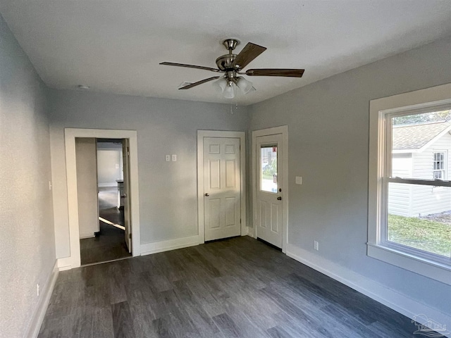 interior space with dark hardwood / wood-style floors and ceiling fan