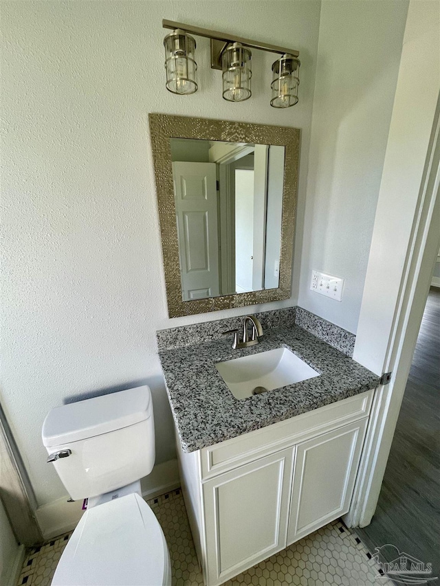 bathroom with vanity, tile patterned floors, and toilet