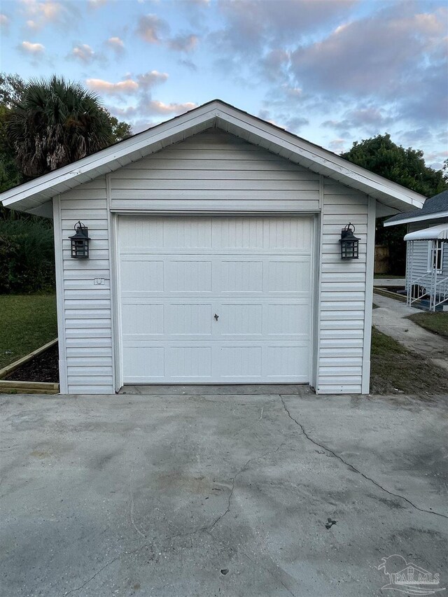 view of garage at dusk