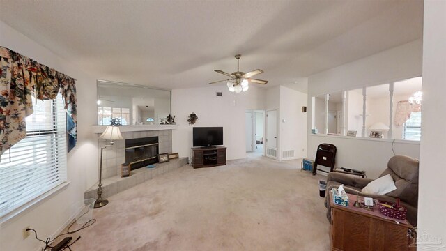 living room featuring ceiling fan, a fireplace, and light carpet