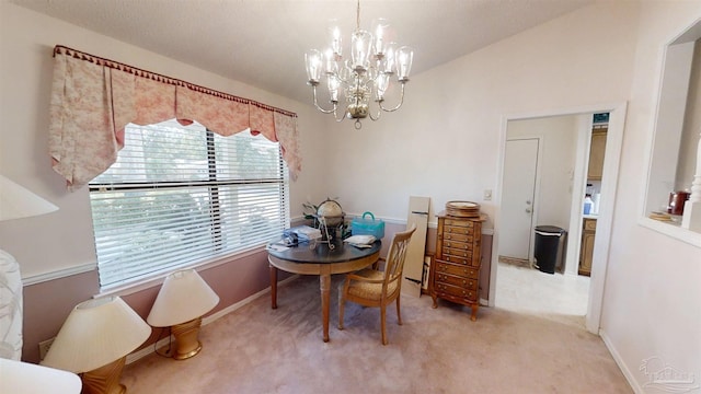 carpeted dining space with a chandelier