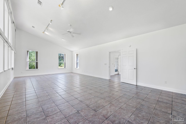 spare room featuring ceiling fan, high vaulted ceiling, dark tile patterned flooring, and track lighting