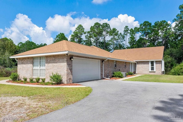 ranch-style house with a garage and a front lawn