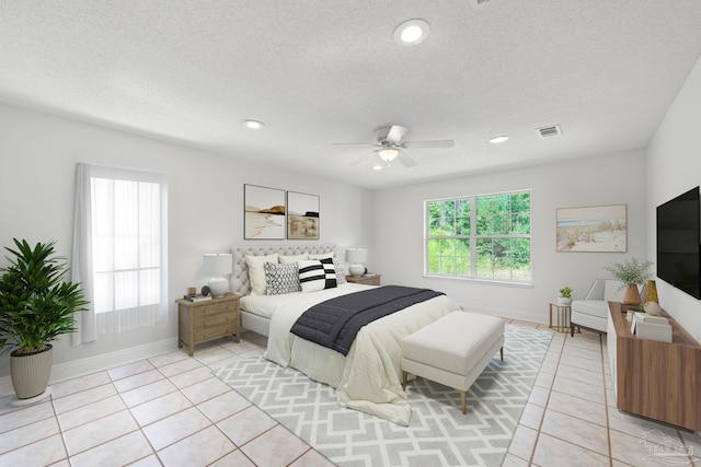 bedroom with a textured ceiling, ceiling fan, and light tile patterned flooring