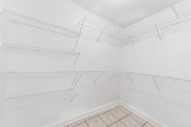 spacious closet featuring tile patterned floors