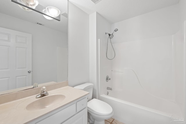 full bathroom with tile patterned floors, vanity, a textured ceiling, washtub / shower combination, and toilet