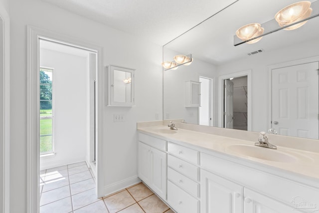 bathroom featuring tile patterned floors, a wealth of natural light, vanity, and a shower with shower door