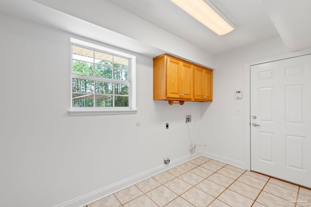 laundry room with hookup for an electric dryer, hookup for a washing machine, cabinets, and light tile patterned flooring