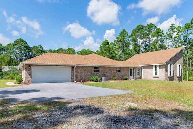 single story home with a garage, central air condition unit, and a front yard