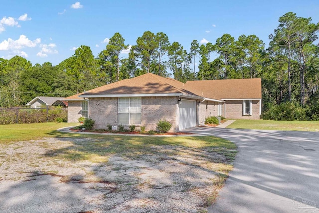 ranch-style house featuring a garage and a front lawn