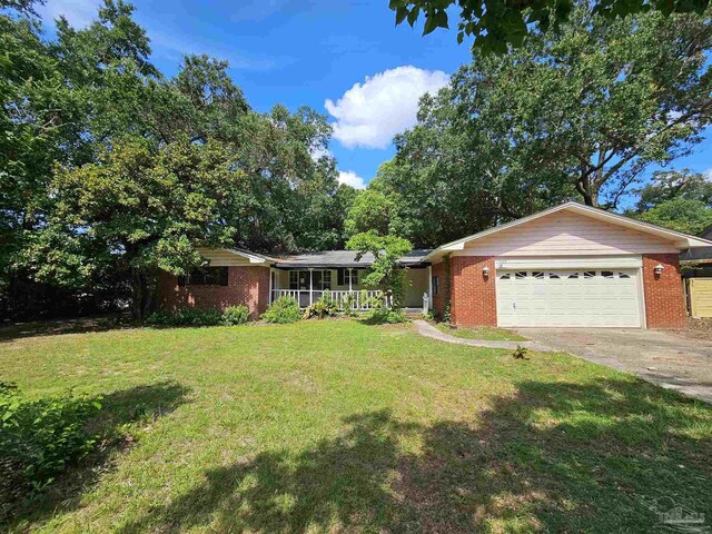 single story home featuring a garage and a front lawn