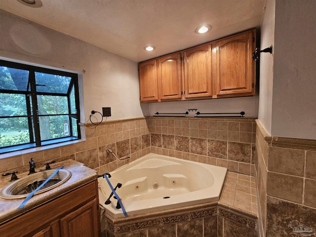 bathroom featuring sink, tile walls, and tiled tub